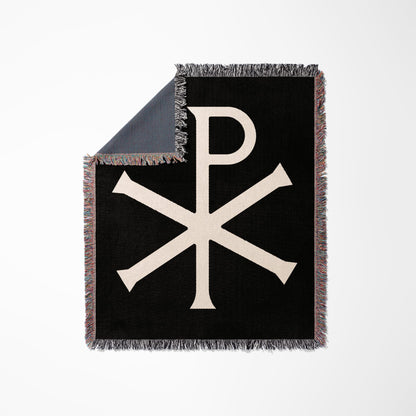 Black woven throw blanket with a cream Chi Rho symbol.
