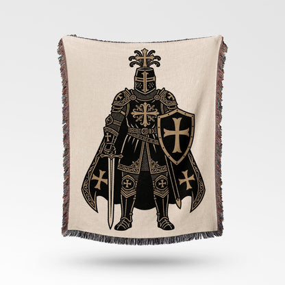 Knight in armor with sword and shield on a woven blanket.