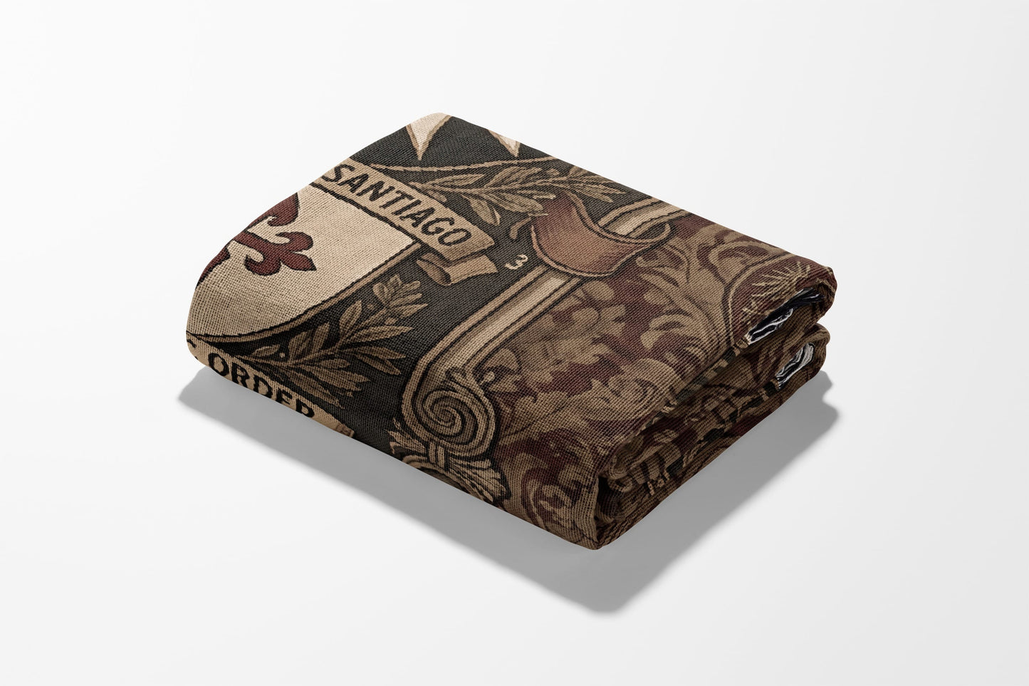 Folded blanket with "Santiago Order" text and ornate pattern on white background.