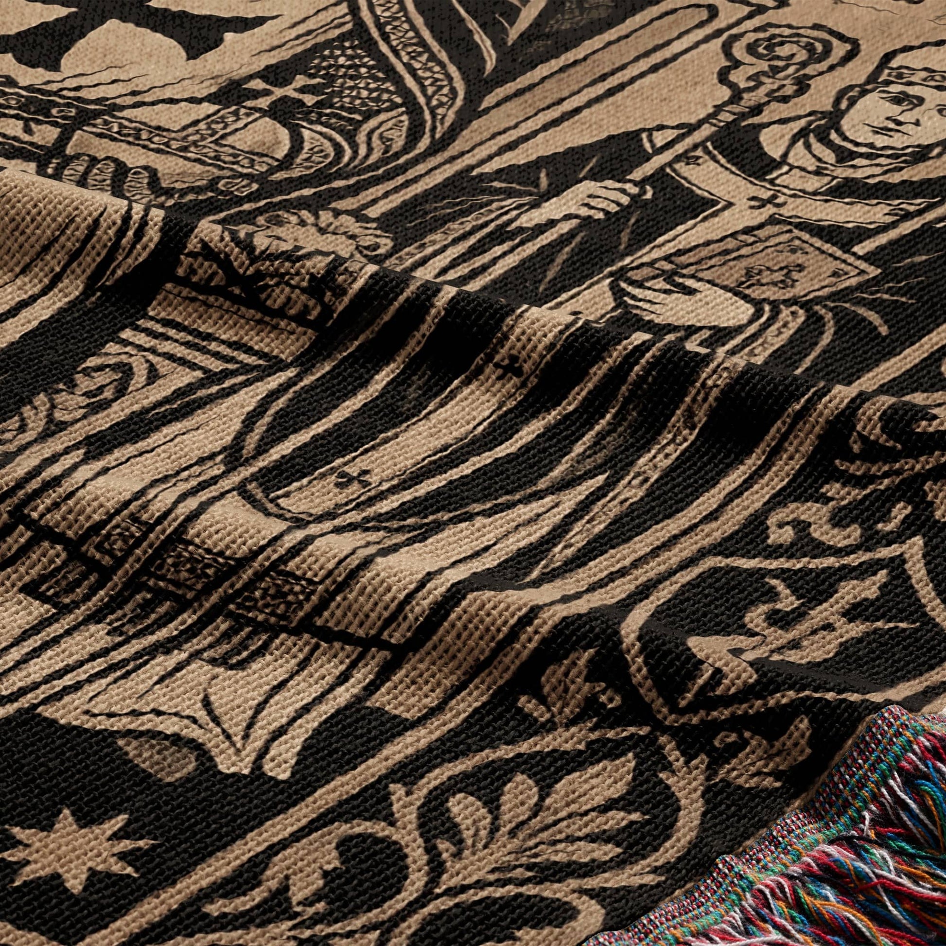 Tapestry with medieval figure holding staff and book, fringed edge.