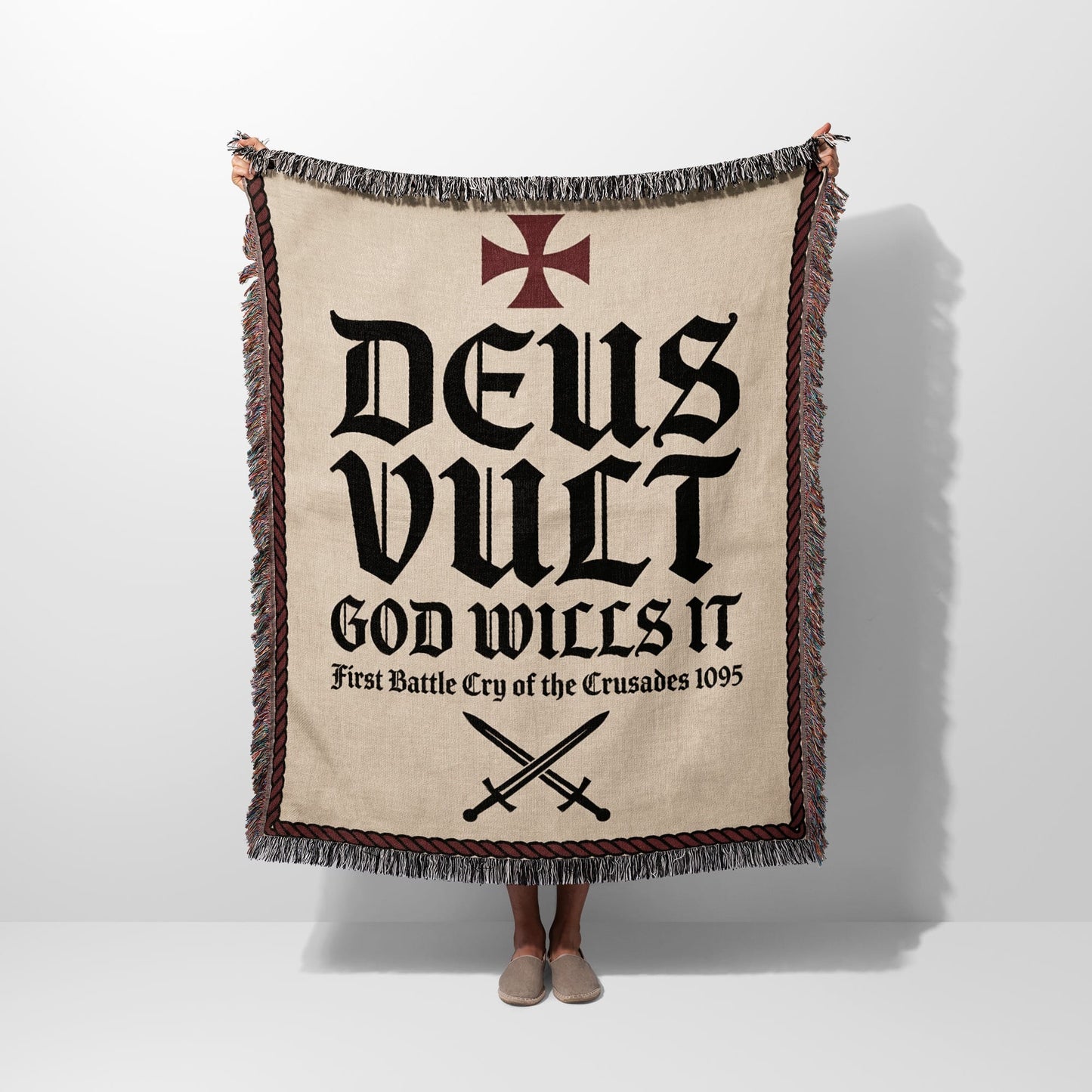 Blanket with "Deus Vult" and crossed swords design.