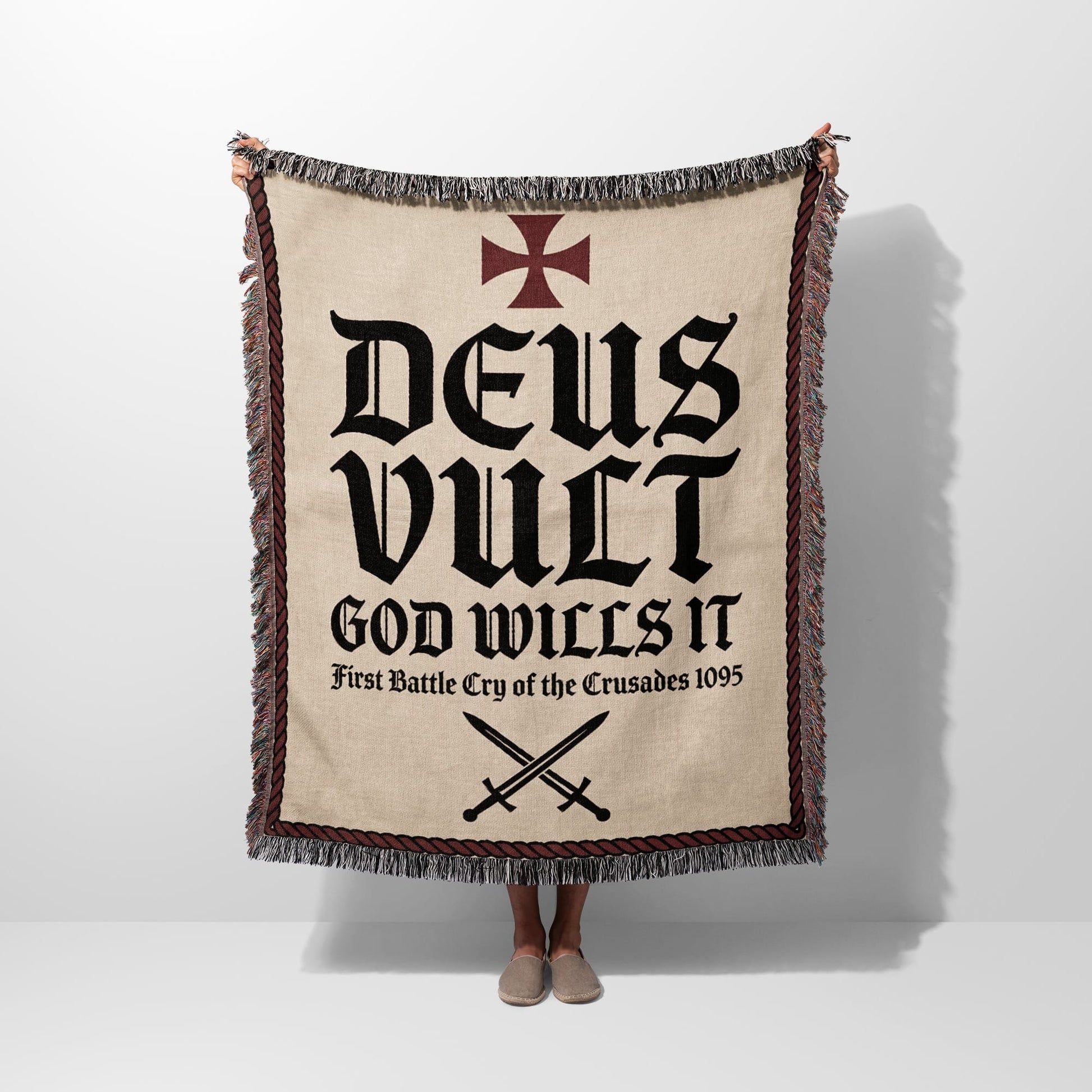 Blanket with "Deus Vult" and crossed swords design.