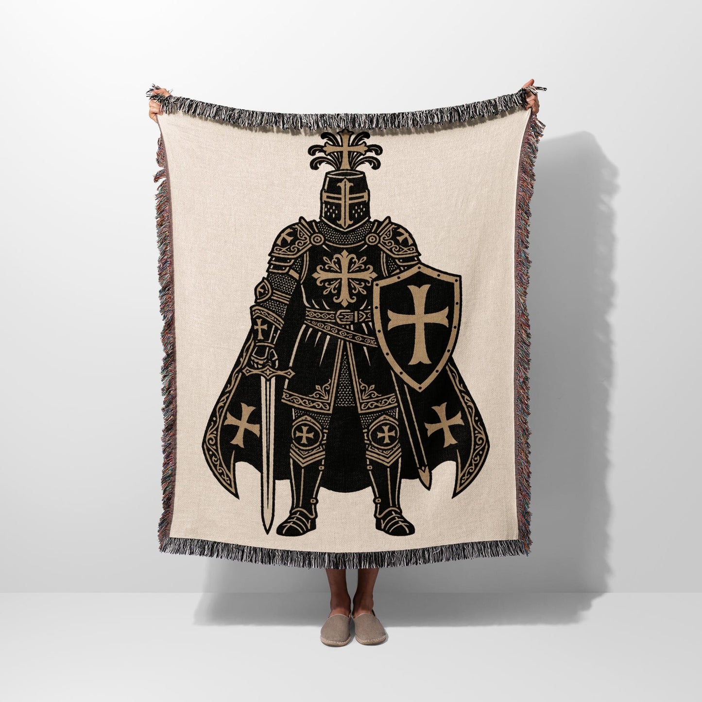 Tapestry blanket with knight in full armor holding sword and shield.
