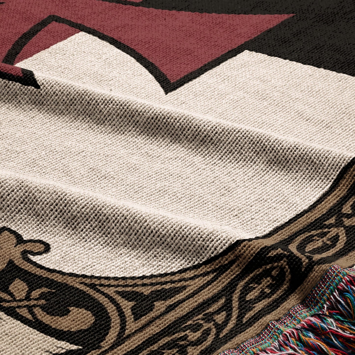 Close-up of a woven blanket with geometric and ornamental patterns.