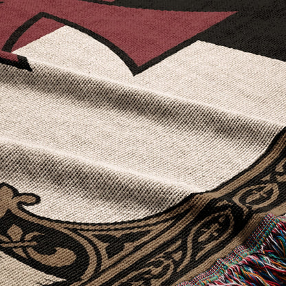 Close-up of a woven blanket with geometric and ornamental patterns.