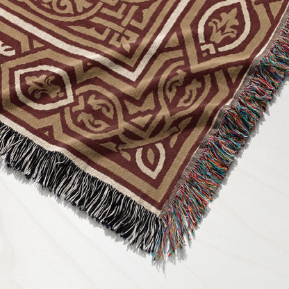 Brown and tan geometric pattern blanket with multicolored fringe.