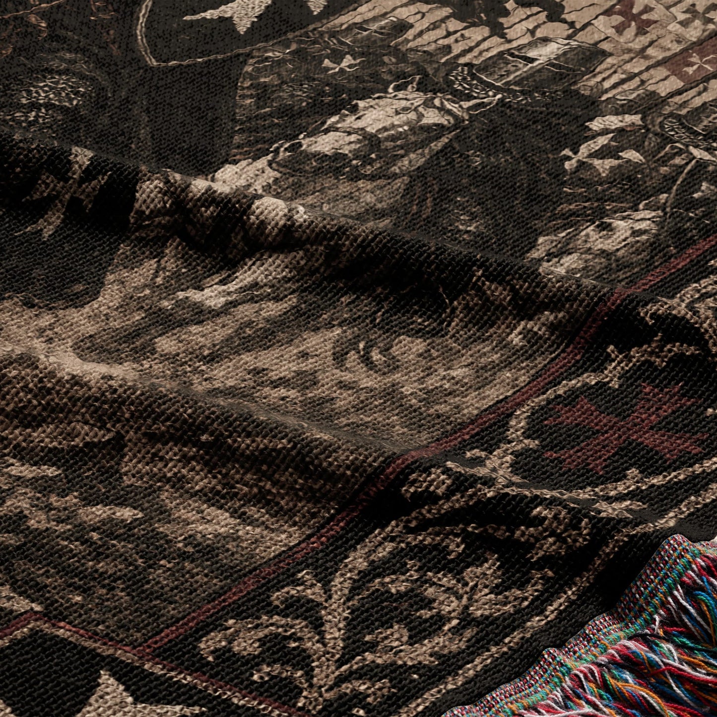 Dark woven tapestry with detailed pattern and colorful fringed edge.