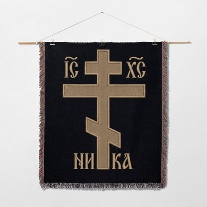 Orthodox Christian cross with "INRI" and "IC XC" text on black fabric.
