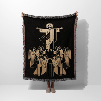 Jesus with open arms surrounded by angels on a black woven blanket.