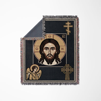 Tapestry blanket with Jesus' face and an angel, featuring Celtic knot crosses.