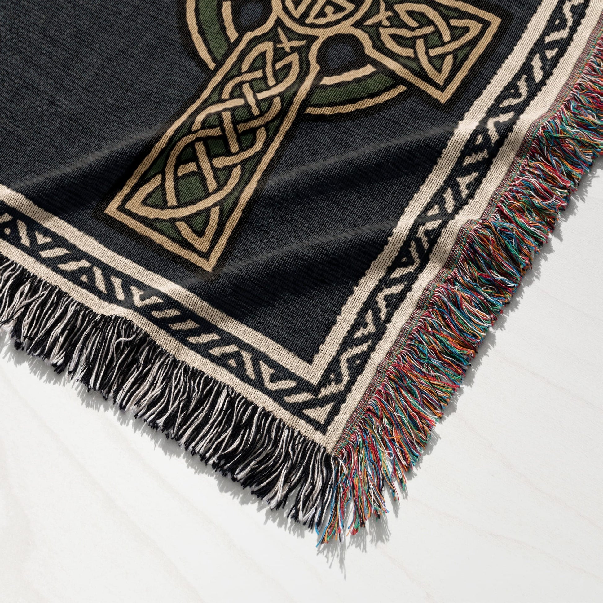 Black throw blanket with Celtic knot cross design and fringed edges.