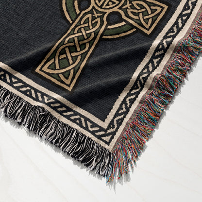 Black throw blanket with Celtic knot cross design and fringed edges.