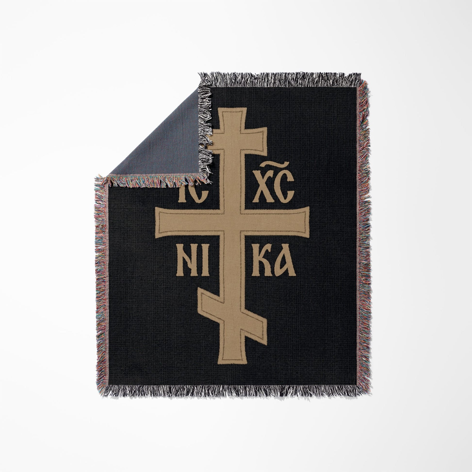 Black throw blanket with tan Orthodox Christian cross and Greek letters.