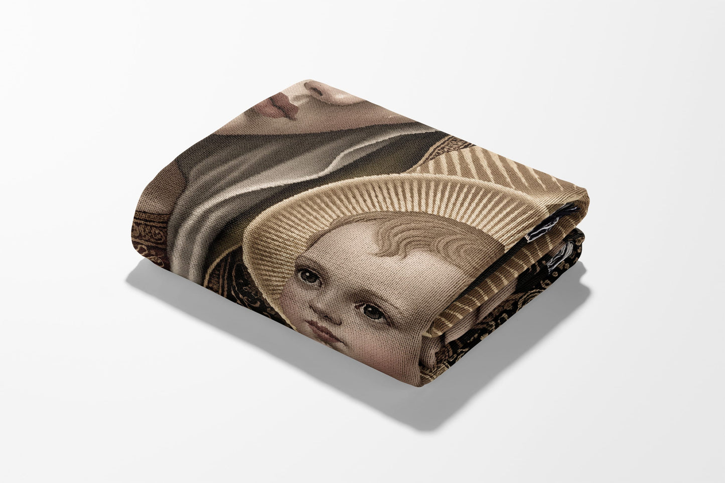 Folded tapestry featuring Virgin Mary and baby Jesus art.