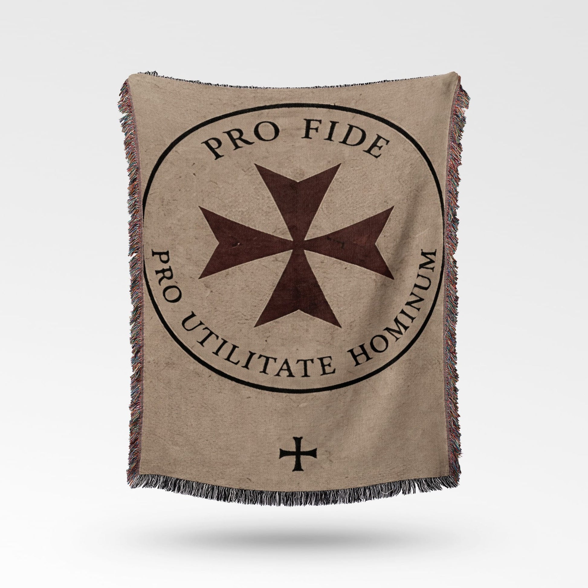 Brown Maltese cross on a tan blanket with text "PRO FIDE UTILITATE HOMINUM".