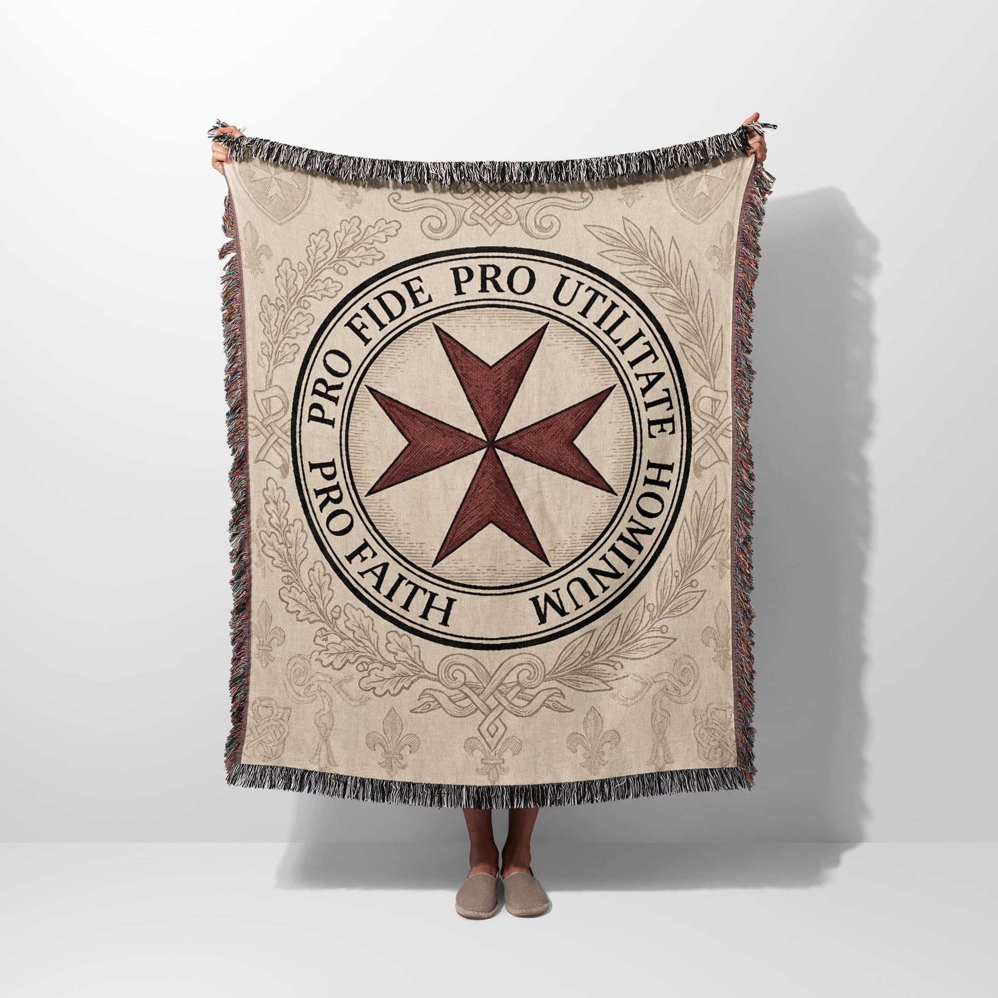 Beige blanket featuring a red Maltese cross and Latin text.
