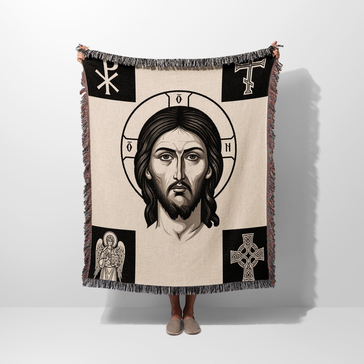 Tapestry blanket with Jesus' face, cross, angel, and Celtic cross motifs.