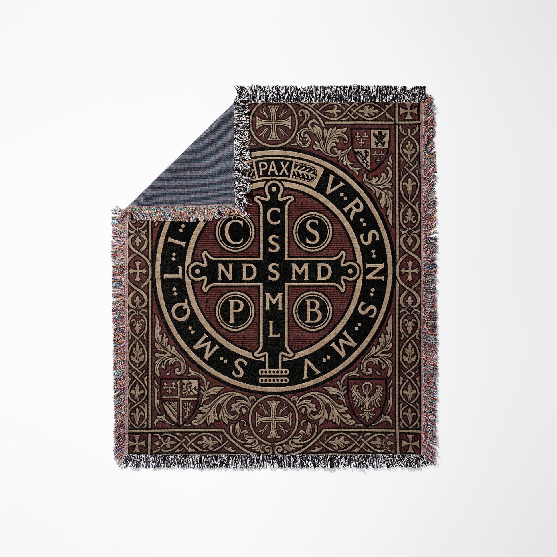 Woven blanket featuring the St. Benedict medal with Latin text and ornate border.