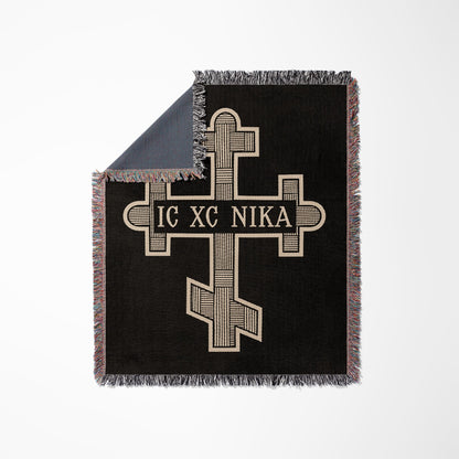 Black woven blanket with Orthodox cross and text "IC XC NIKA" and fringe.