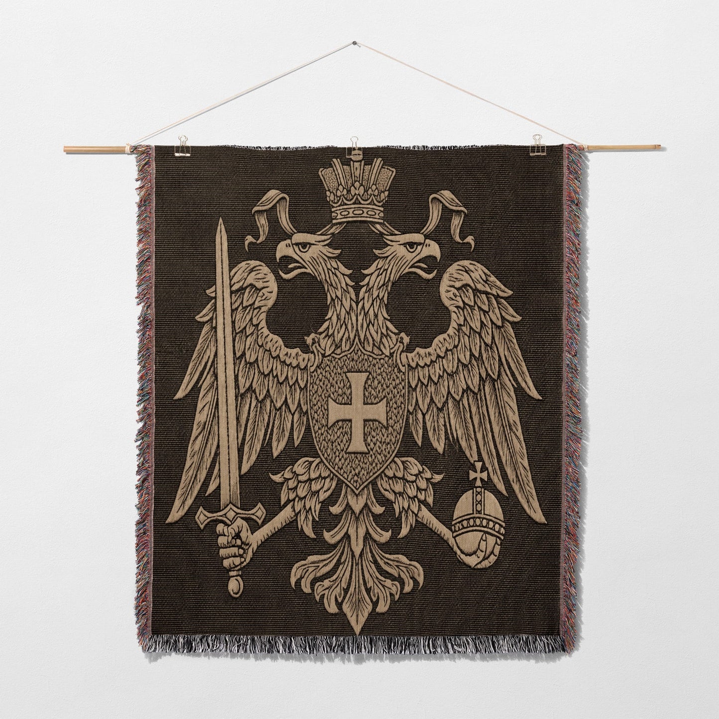 Embroidered tapestry of a double-headed eagle holding sword and orb.