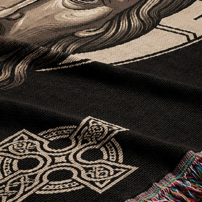 Black throw blanket with intricate Celtic knot design and detail of a person's face.