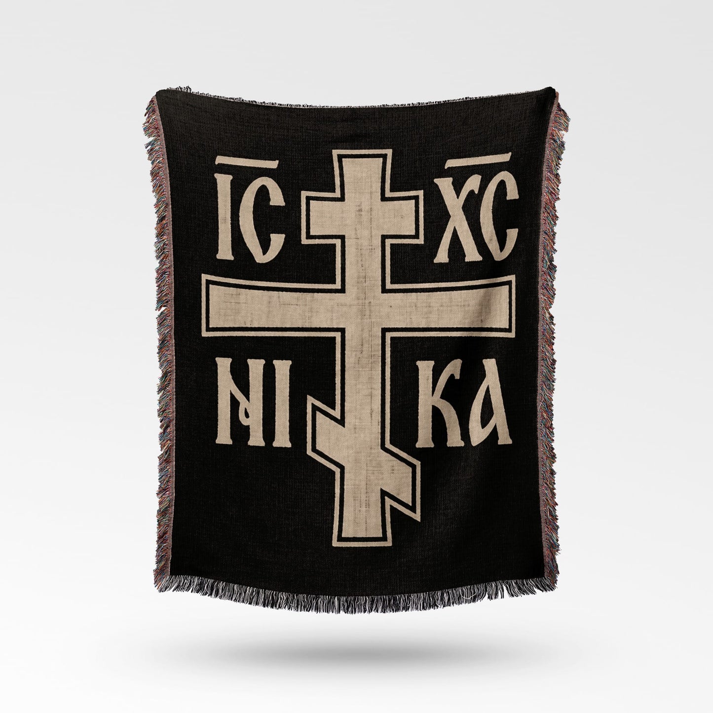 Black throw blanket with a large beige Orthodox cross and text.