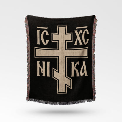 Black throw blanket with a large beige Orthodox cross and text.