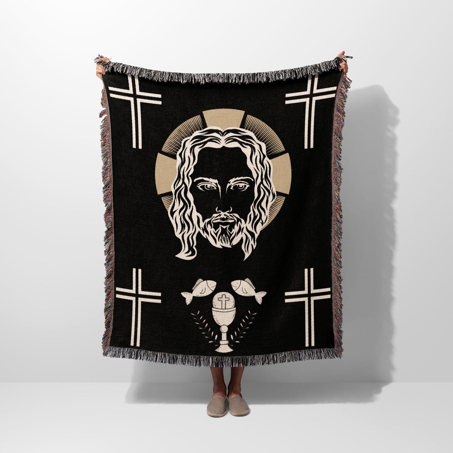Black throw blanket featuring Jesus' face, crosses, and a chalice with fish.