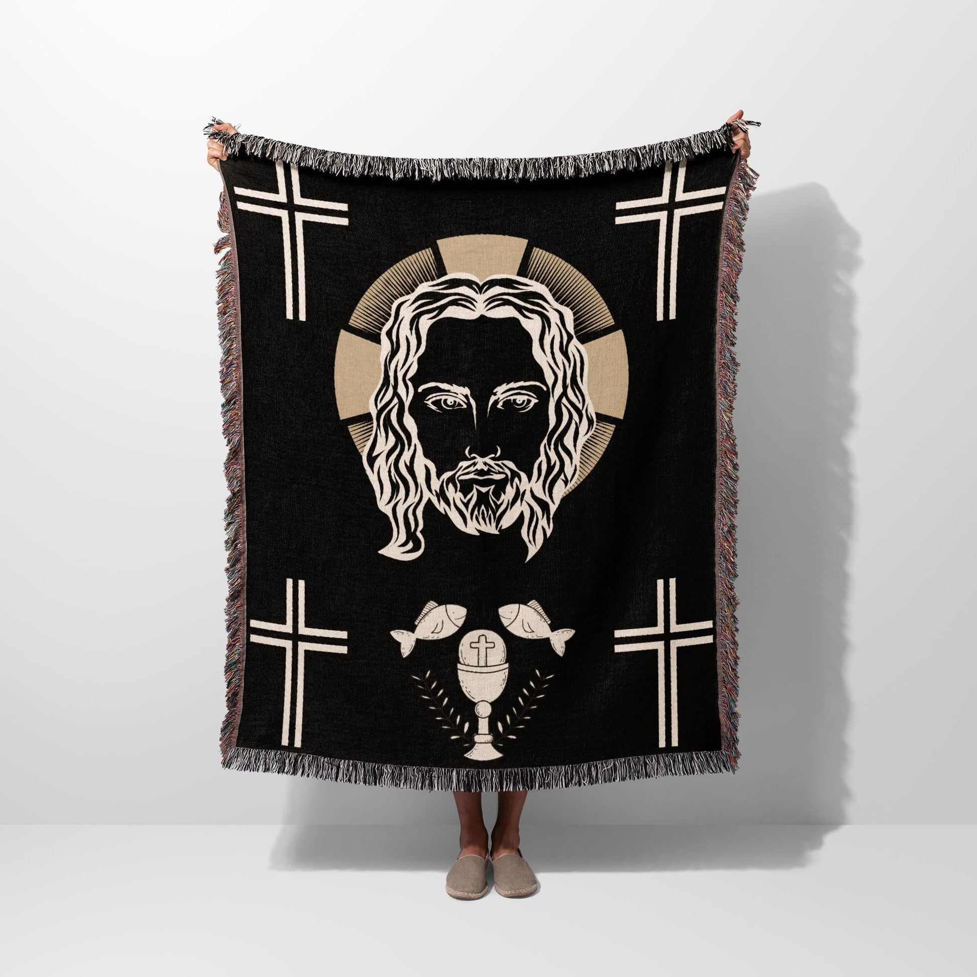 Black throw blanket featuring Jesus' face, crosses, and a chalice with fish.