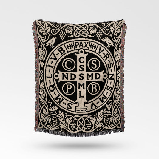 Black and beige woven throw blanket with Saint Benedict medal design and fringe.