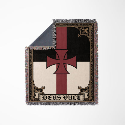 Tapestry with a red cross and "DEUS VULT" text on a white background.