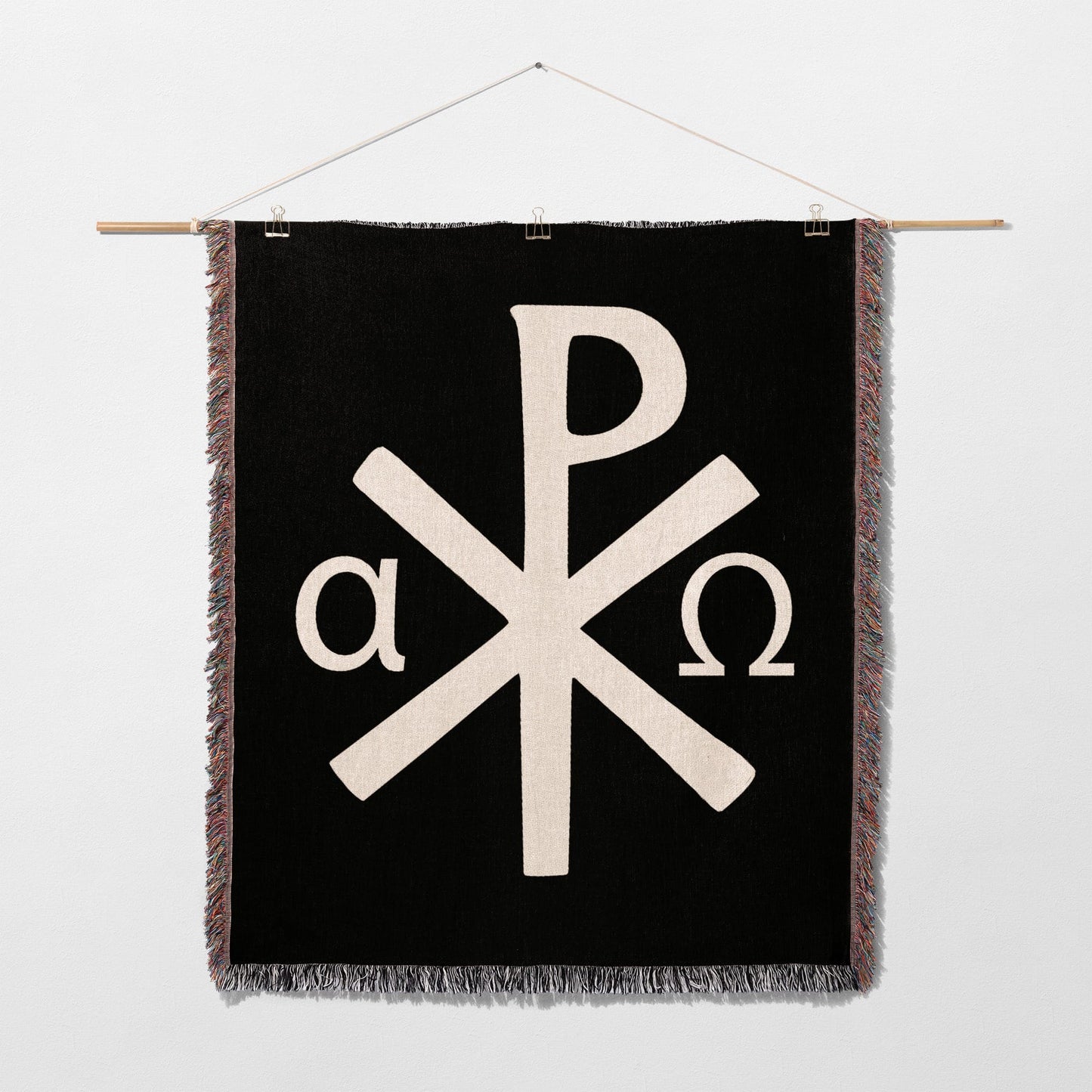 Black tapestry with white Chi-Rho symbol and alpha and omega.