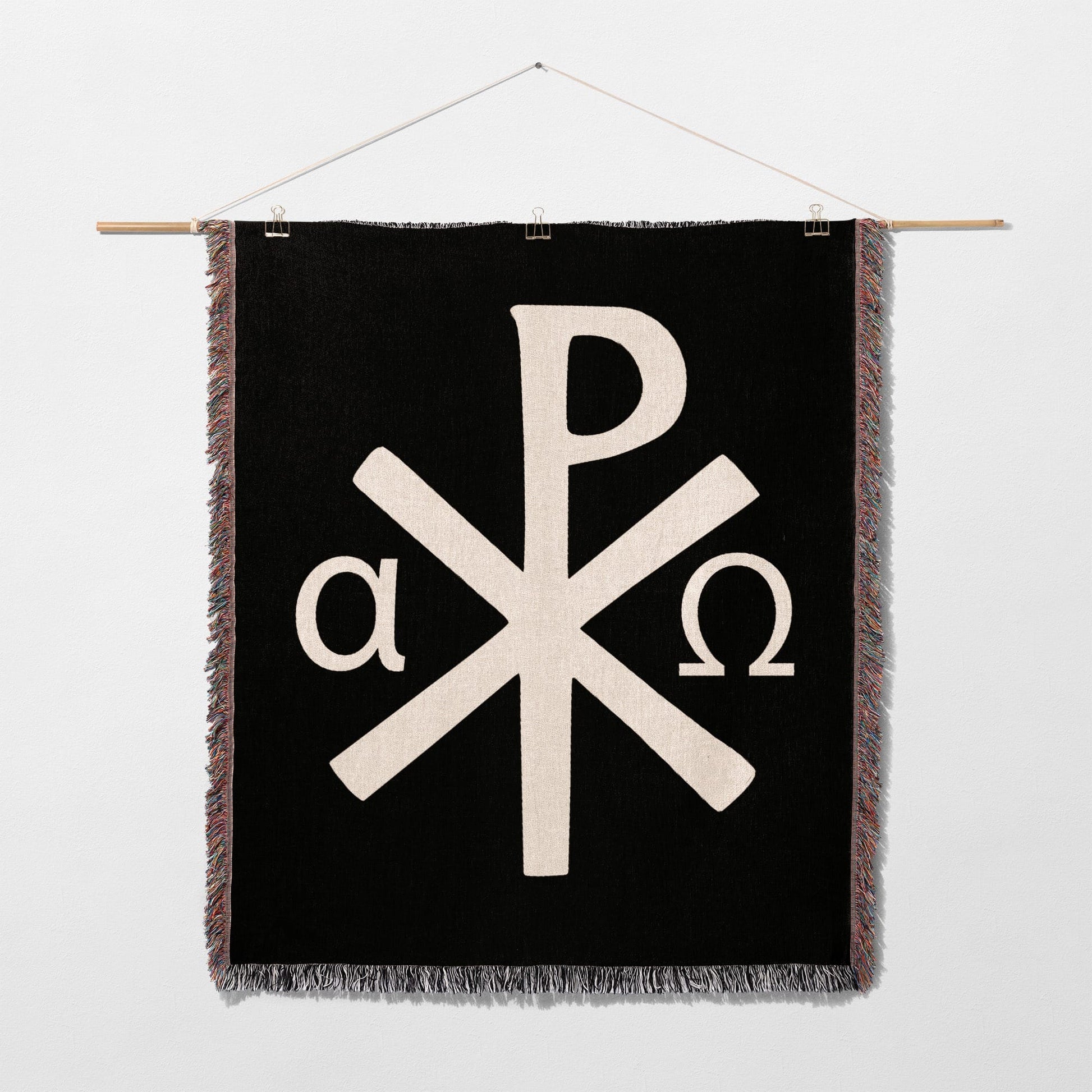 Black tapestry with white Chi-Rho symbol and alpha and omega.