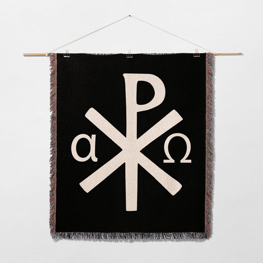 Black tapestry with white Chi-Rho symbol and alpha and omega.