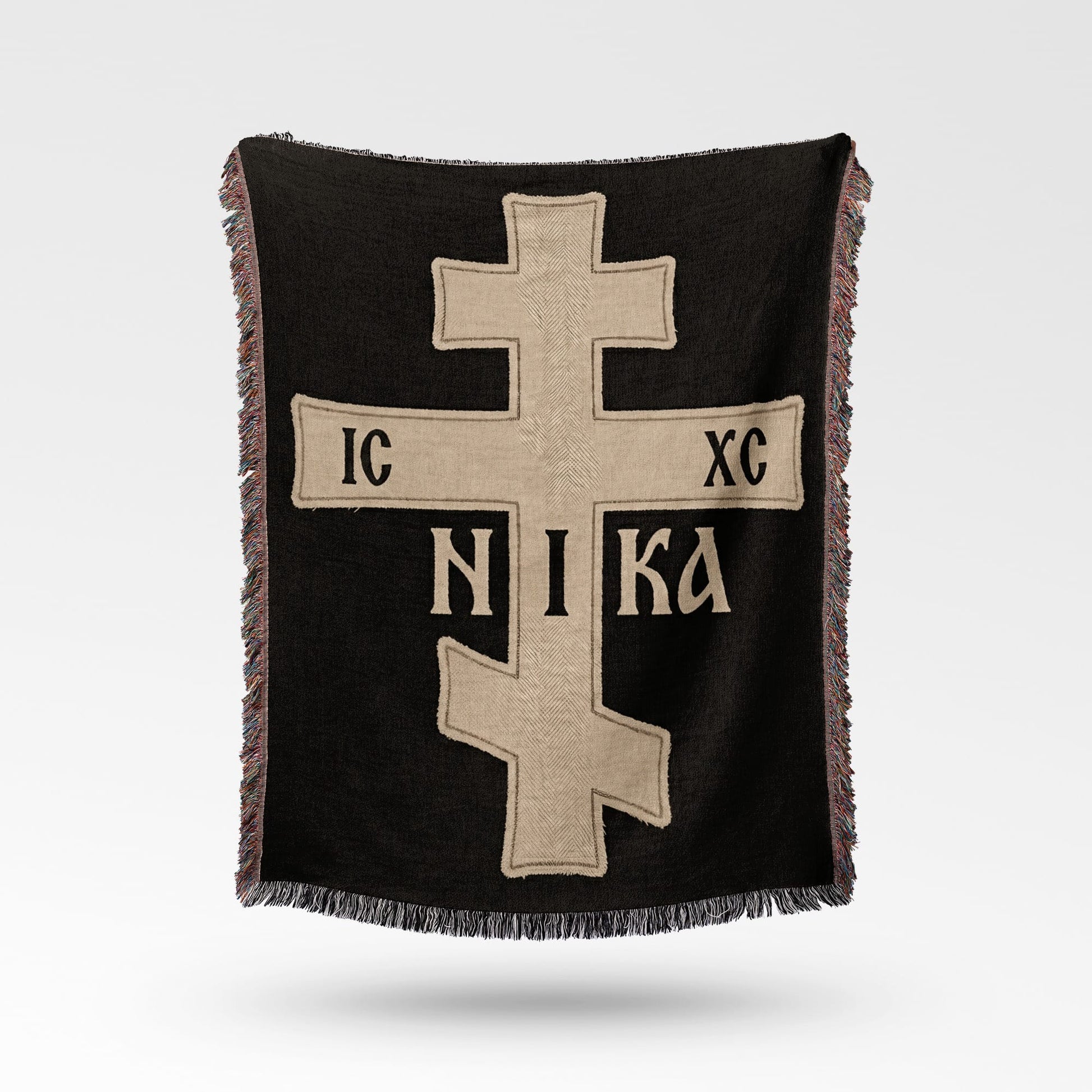 Black throw blanket with a beige Orthodox cross and "IC XC NIKA" inscription.