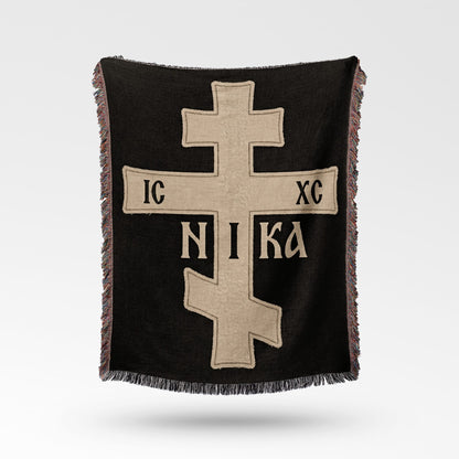 Black throw blanket with a beige Orthodox cross and "IC XC NIKA" inscription.