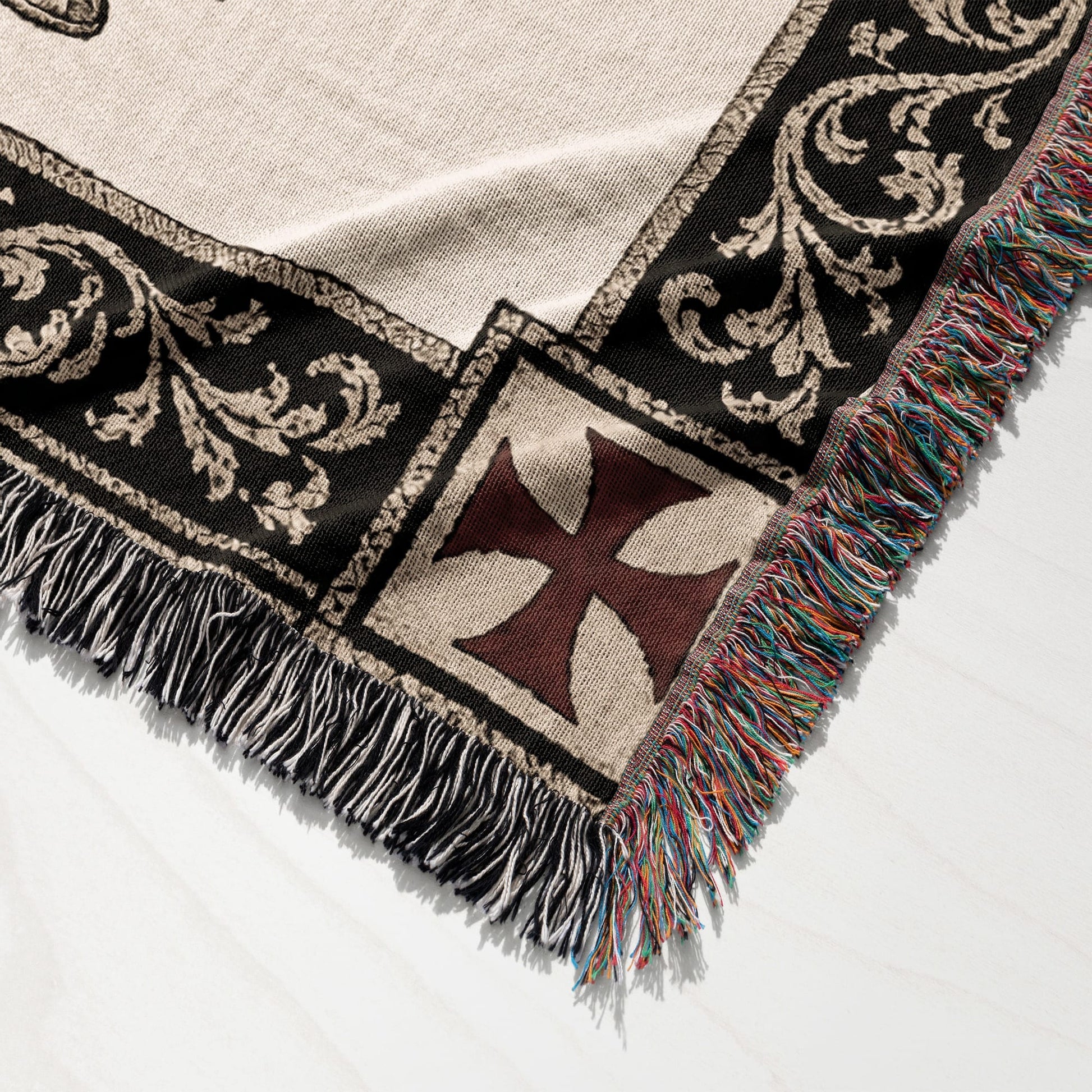 Woven blanket with a Templar cross and ornate border, fringed edges.
