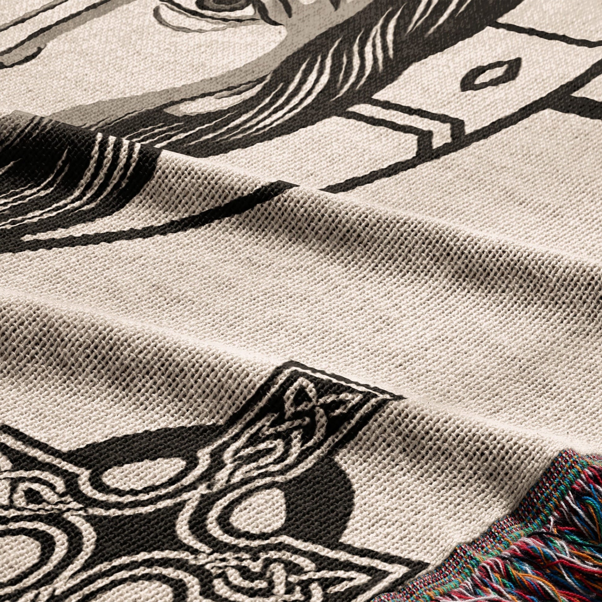 Woven blanket with intricate black and white Celtic knot and horse design.