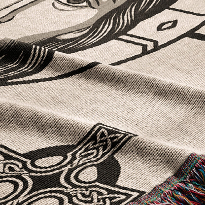 Woven blanket with intricate black and white Celtic knot and horse design.