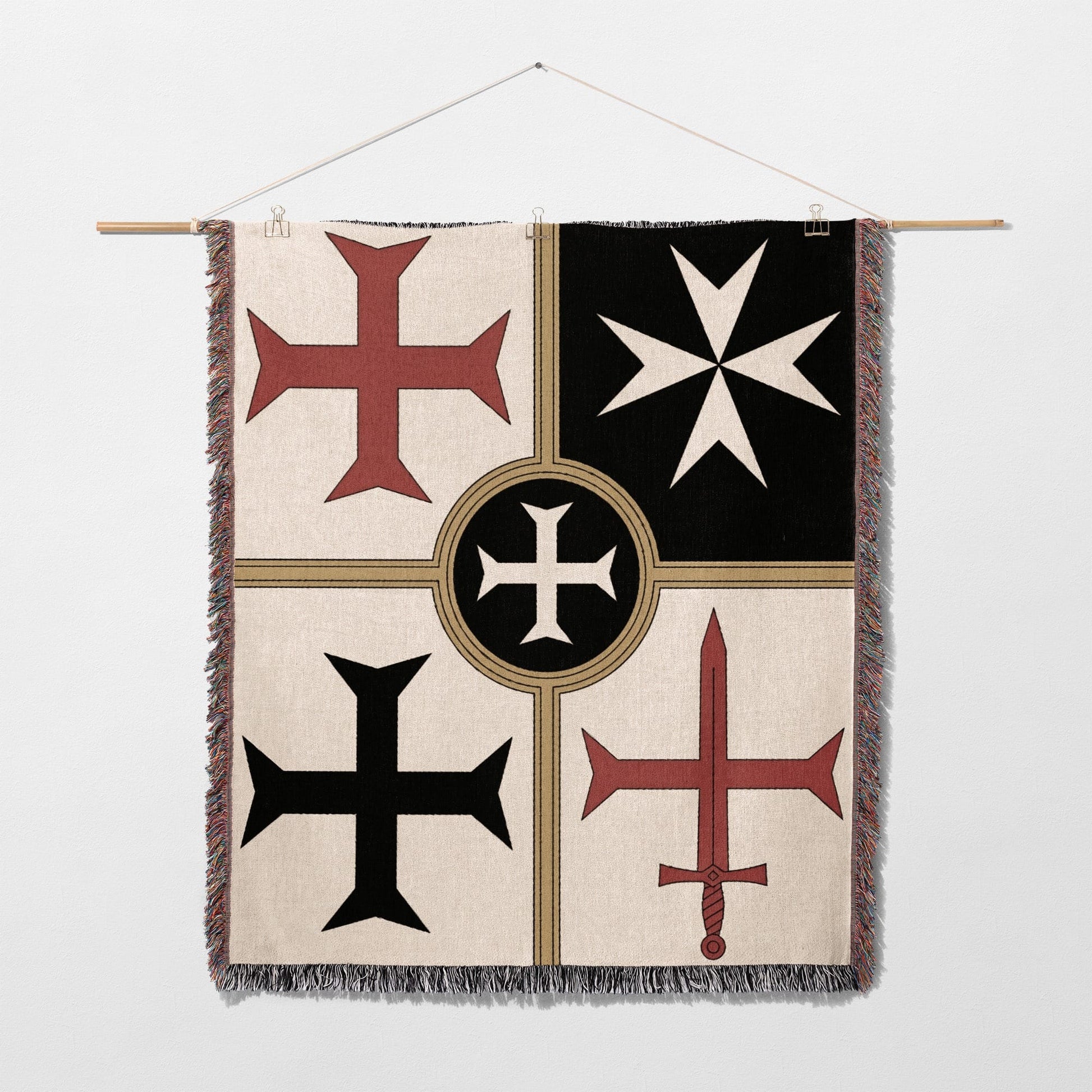 Four heraldic crosses on a cream, black, and red tapestry hanging on a wall.