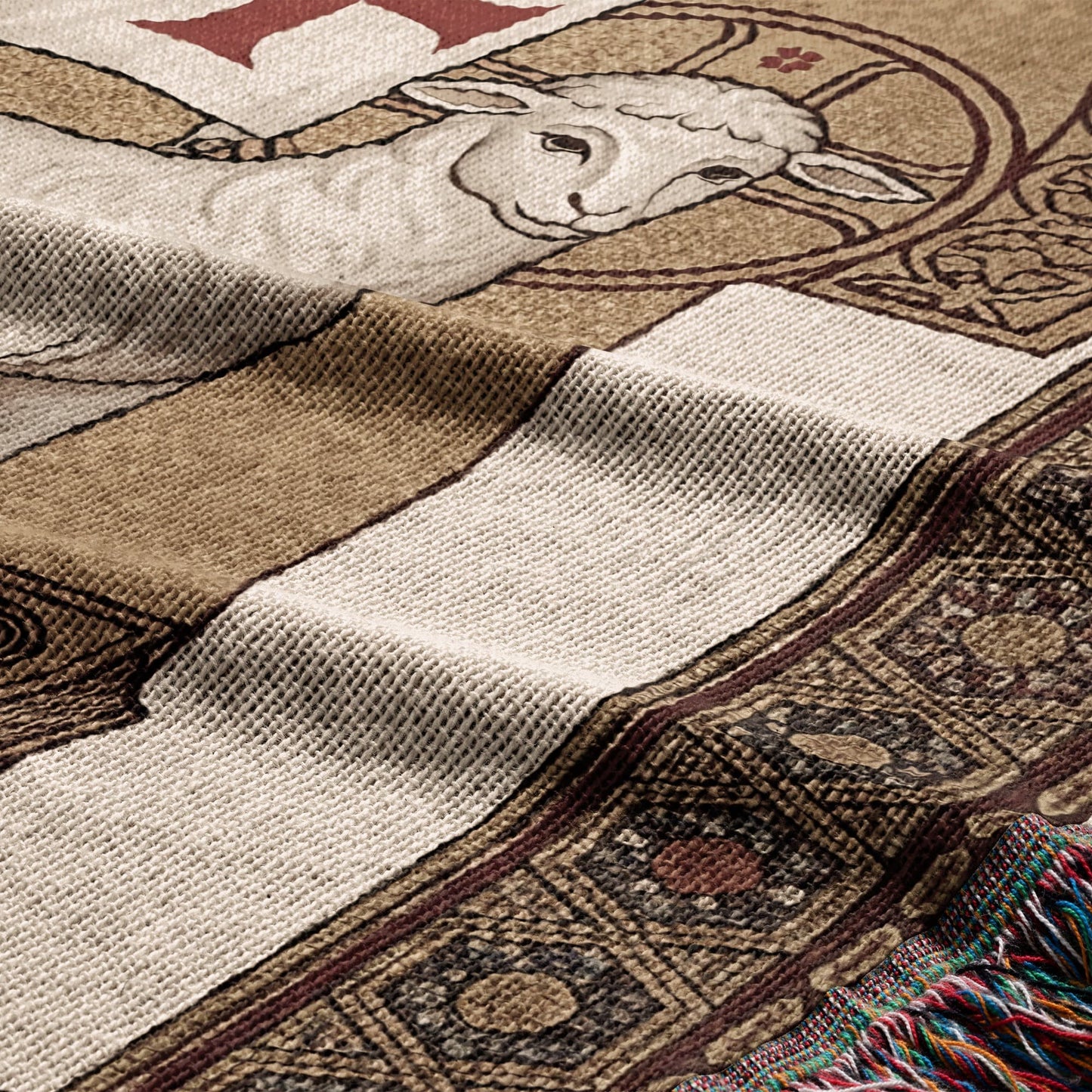 Woven blanket with a lamb design and patterned border, showing textile texture.