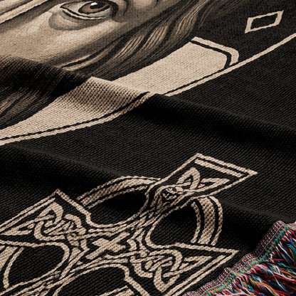 Black woven blanket with a portrait and Celtic knot design.