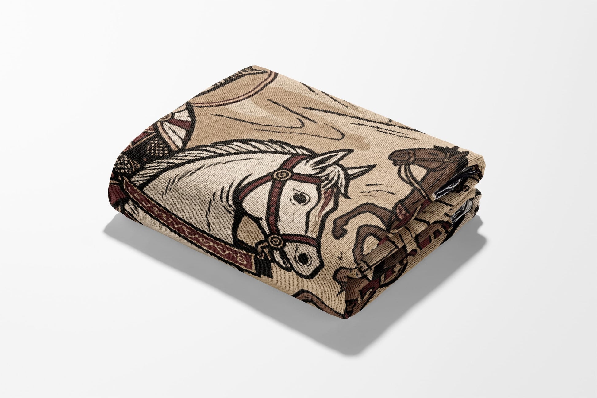 Folded blanket with western-themed horse and cowboy pattern.