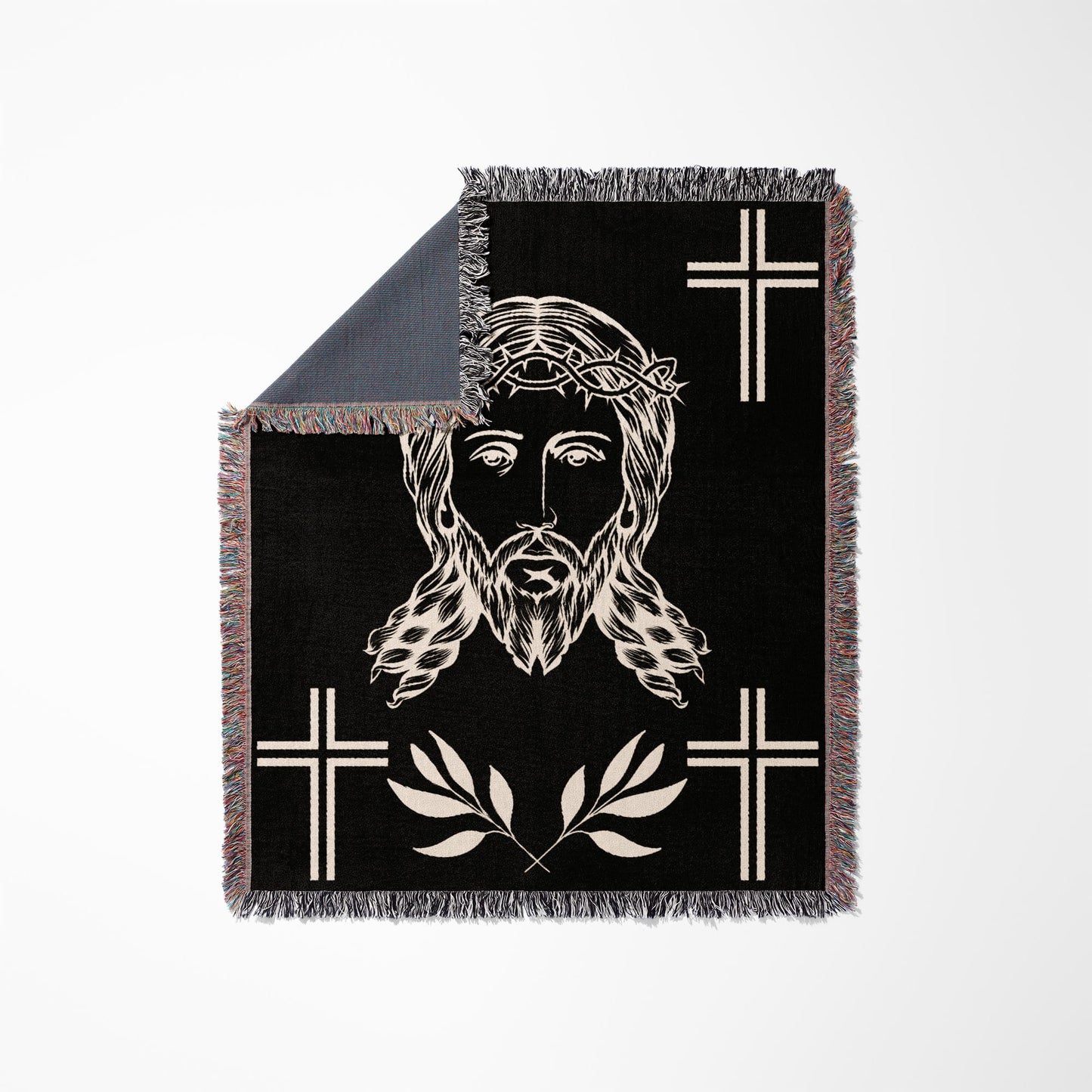 Jesus Christ's face with crown of thorns, surrounded by crosses and olive branches on a black blanket.